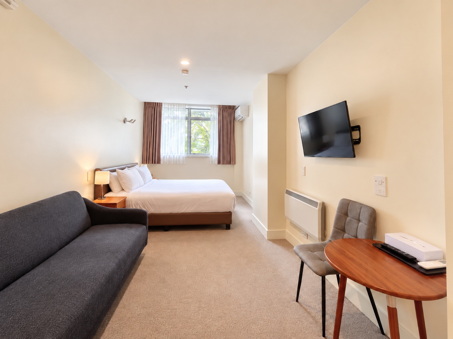 Deluxe King | full-room view with sofa and dining table