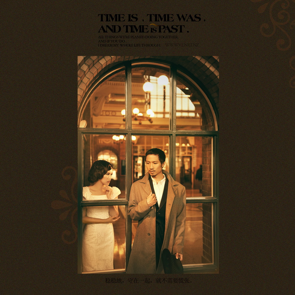 A couple photographed within an arched window of the Booking Hall.