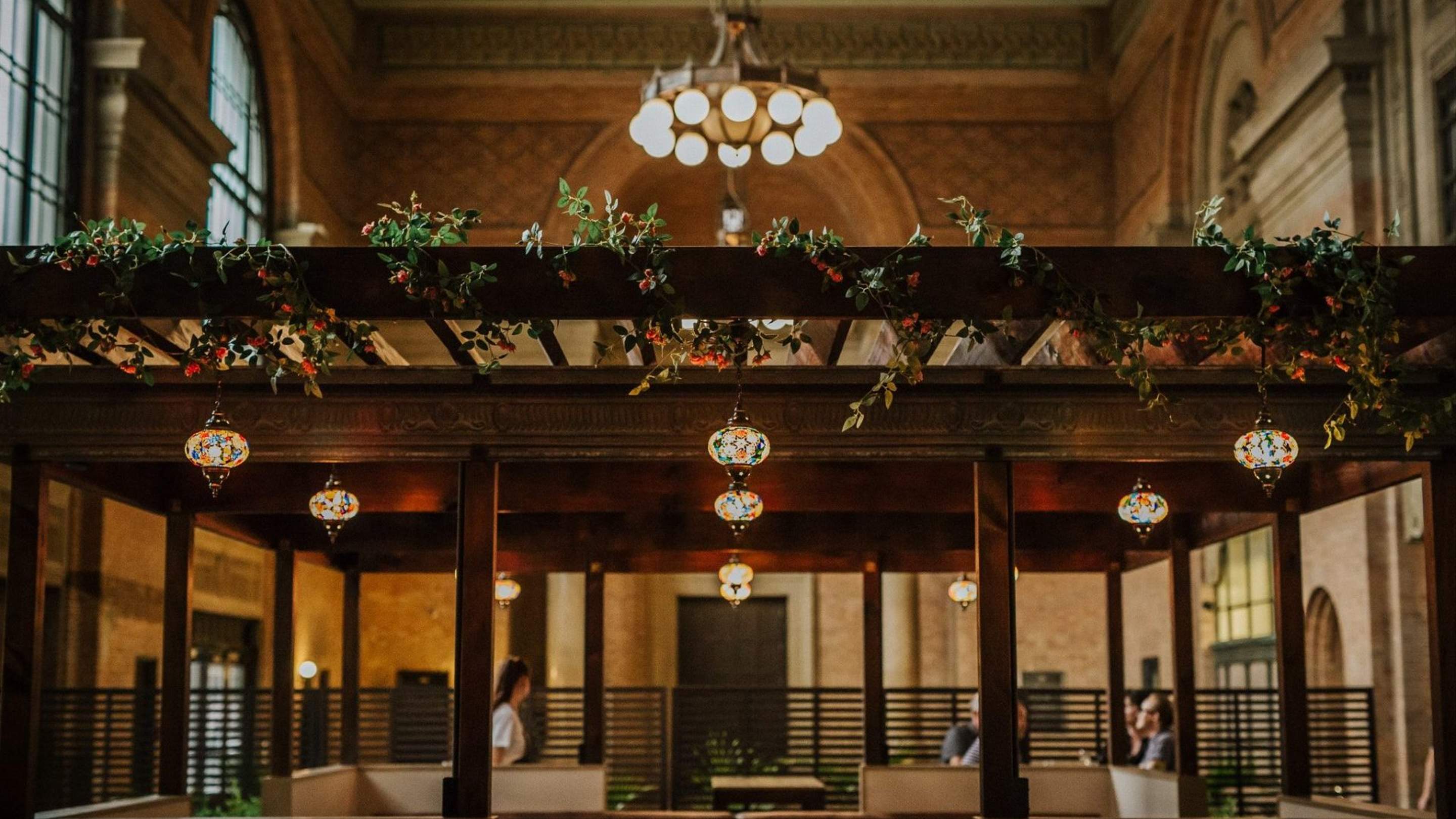 Warm pendant lights and greenery above the Saffron dining room.