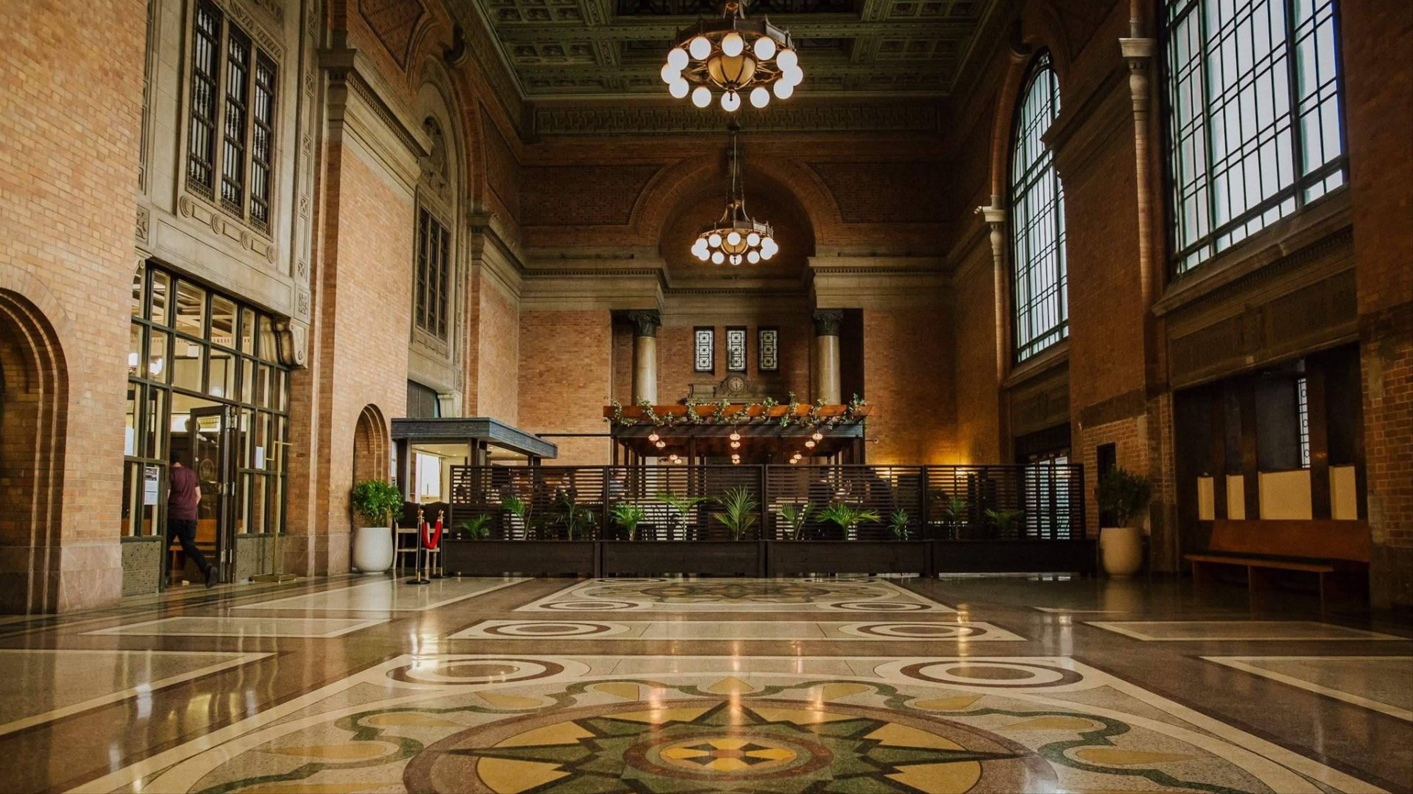 Saffron set within the brick arches and chandeliers of the Grand Hall.