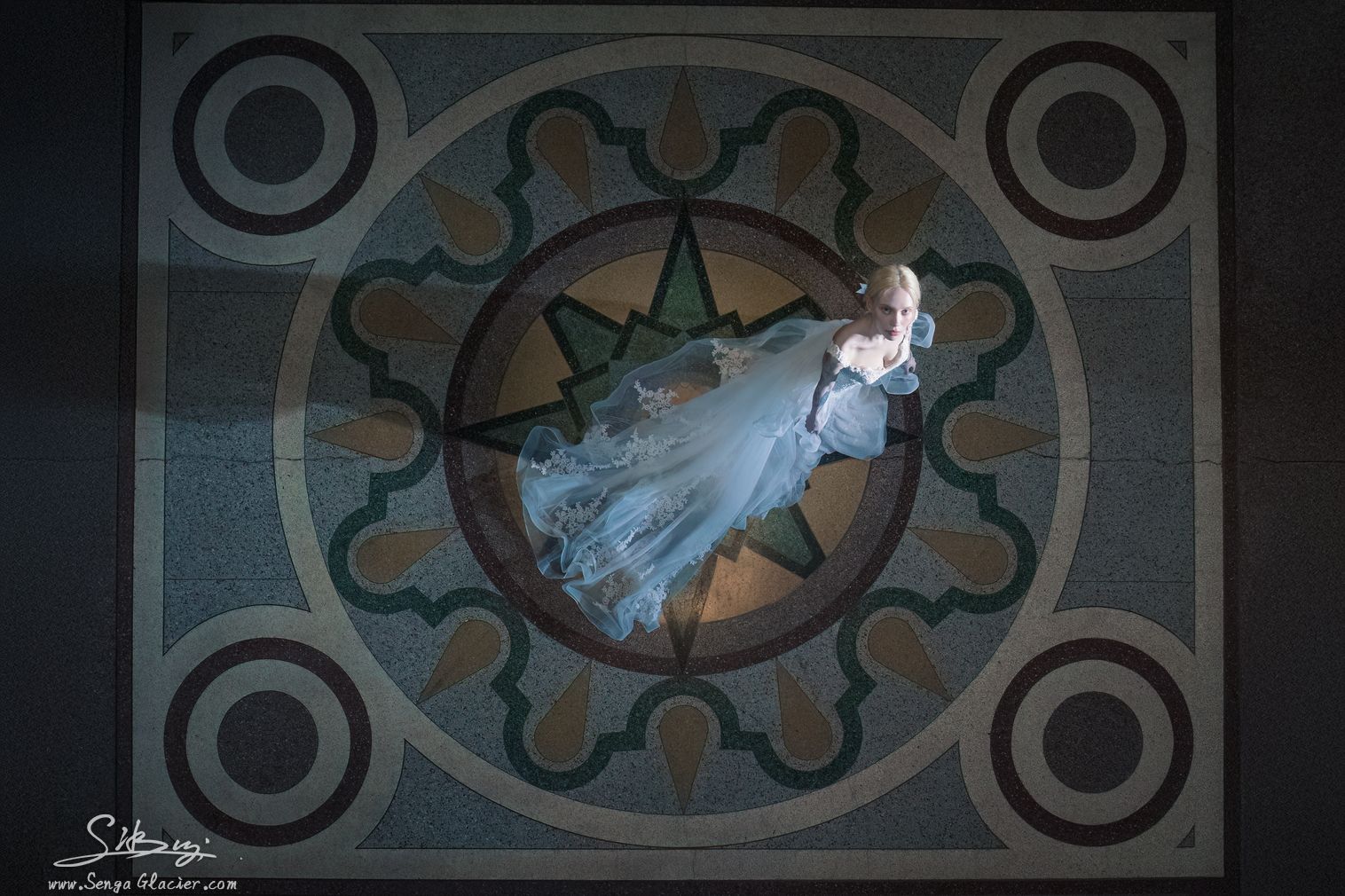 An overhead bridal portrait centred on the station's circular terrazzo motif.