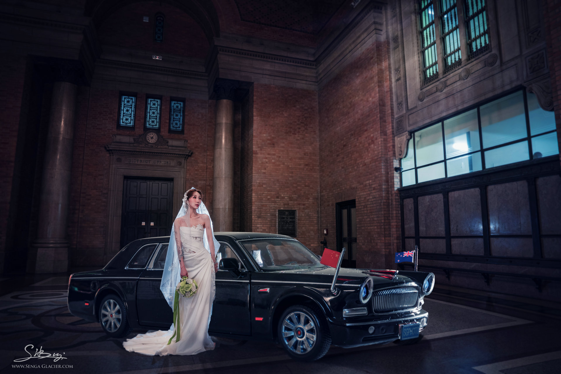 A bride photographed beside a formal car in the Grand Foyer.