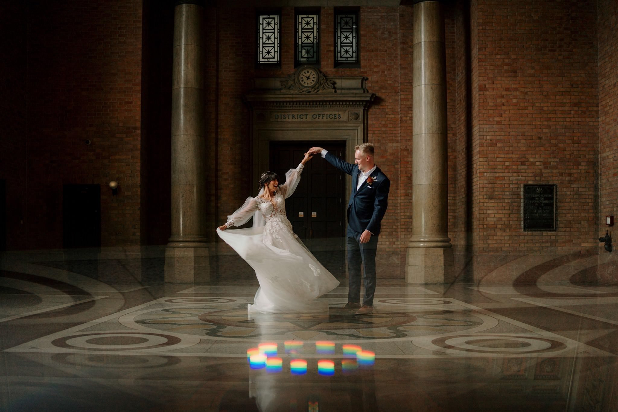 A newly married couple dancing beneath the Grand Foyer clock.